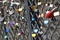 Many colorful love padlocks on fence