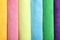 Many colorful microfiber cloths as background, top view