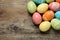 Many colorful painted Easter eggs on wooden background, top view.