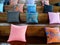 Many colorful pillow putting on wooden stairs.