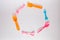 Many colorful plasic forks, spoons and knives on white background with copy space, top view. Devices for baby food