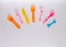 Many colorful plasic forks, spoons and knives on white background with copy space, top view. Devices for baby food