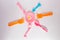 Many colorful plasic forks, spoons and knives on white background with copy space, top view. Devices for baby food