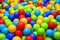 Many colorful plastic balls in a kids` ball. Colorful balls background