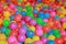 Many colorful plastic balls in a kids` ball pit at a playground