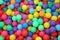 Many colorful plastic balls in a kids` ball pit at a playground