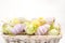 Many colourful easter eggs in basket