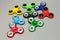 Many colourful fidget finger spinner stress on grey background