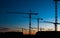 many construction cranes on sunset sky , crane silhouette skyline