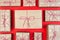 Many craft gift boxes on red background. Christmas packaging wrapped vintage paper knolling presents