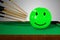 Many cue sticks aiming to hitting a green smiling emoticon happy