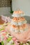 many cupcakes on shelf shelves in wedding party. dessert serving for wedding guest.