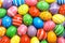 Many decorated Easter eggs as background, top view.