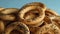 Many delicious ring shaped Sushki dry bagels on light blue background, closeup