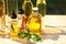 Many different cooking oils on wooden table against blurred green background, closeup. Space for text