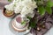 Many different empty tableware. Bouquet of white lilac. Wood background dark napkin