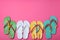 Many different flip flops on pink background, flat lay. Space for text