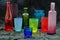 Many Different glass jar and glass cups and surface reflections on a black background. Group of different glassware