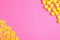 Many different lemon drops on pink background, flat lay. Space for text