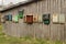 Many different mailboxes are attached to the barn