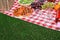 Many different products on checkered picnic blanket