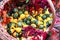 Many diverse small decorative pumpkins in a wicker basket