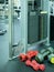 Many dumbbells near training machine in gym