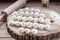 Many dumplings on wooden desk with flour