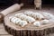 Many dumplings on wooden desk with flour
