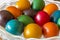 Many Easter colored eggs in the basket.
