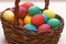 Many Easter colored eggs in the basket. Close-up