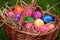 Many Easter eggs in a brown basket
