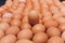 Many eggs lie together on each other, brown eggs, a lot of chicken eggs.