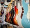 Many electric guitars body aligned in the store