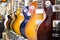 Many electric guitars body aligned in the store