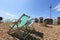 Many empty striped folding beach chairs on Brighton costline, tower i360