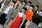 Many fashion mannequins in the clothes shop window