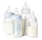 Many feeding bottles with infant formula on white background