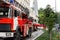 Many fire engine trucks with ladder and safety equipment at accident in highrise tower residential apartment or office
