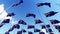 Many flags of Australia waving in the wind against blue sky.