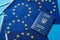 Many flags of the European Union and the passport of Ukraine, close-up, the concept