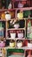 Many flowers in pots on wooden shelves lined up as decor