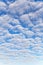 Many fluffy white clouds against blue sky background