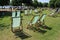 Many folding chairs in Hyde Park in the city London.