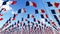 Many France Flags flying against clean sky.