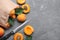 Many fresh ripe apricots and knife on grey table, flat lay. Space for text