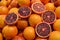 Many fresh ripe organic Spanish oranges displayed for sale in Central Market Hall in Budapest, Hungary, side  view of flat flay of