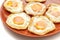 Many fried eggs on the plate, ready to serve, on white background isolated