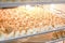 Many frozen dumplings in open manufacturing refrigerator. Frozen semifinished food storage racks