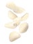 Many garlic cloves falling on white